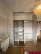 Light artwood wardrobe with hanging and shelves, fitted in Norton